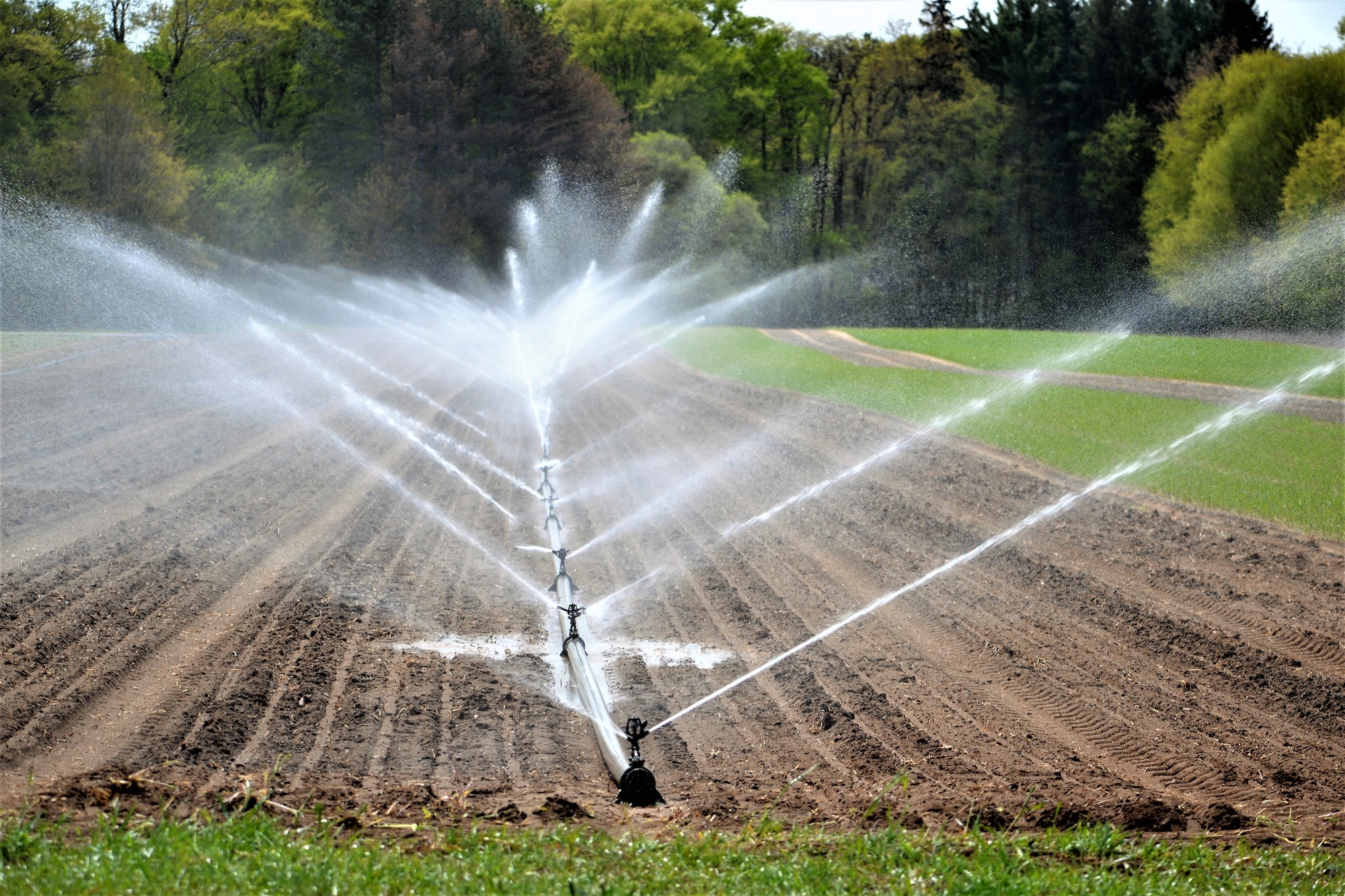 irrigation system watering crops farm land agriculture